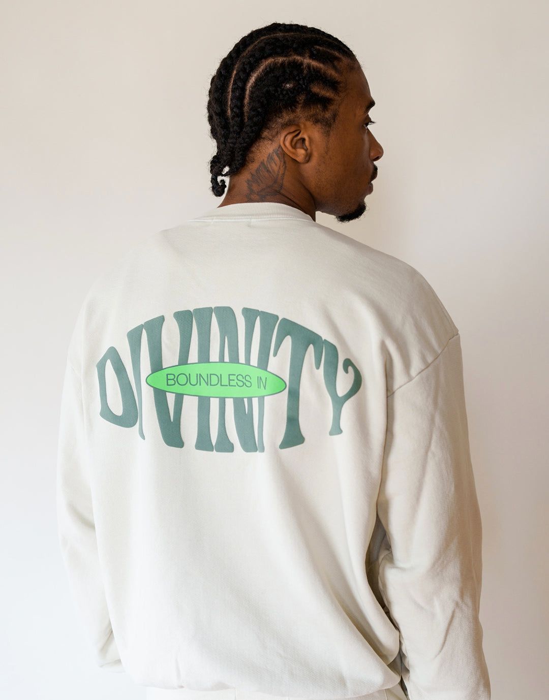Back View of Model wearing size Large. Our Boundless in Divinity Crewneck Sweatshirt features a Boundless in Divnity Puff Print on back 
